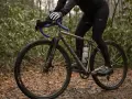 Cyclist adjusting saddle height to prevent calf pain.