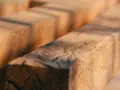 Close-up of rough-hewn wooden beams, evoking the question: was Jesus a carpenter?