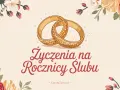 Złote obrączki i kwiaty na tle. Życzenia na rocznicę ślubu, inspirujące cytaty o szczęściu.