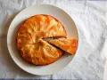 Tarta de manzana esponjosa, dorada y jugosa, con una porción recién cortada lista para disfrutar.