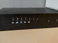 Czarny router Arris TG2492 z widocznym przyciskiem WPS i wskaźnikami stanu: Power, US/DS, Online, 2.4 GHz, 5 GHz, Tel 1, Tel 2.