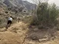 Dust flies as cyclists tackle a rugged trail, enjoying mountain biking in Los Angeles.