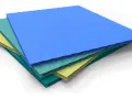 Corrugated plastic sheets in blue, teal, and yellow, offering alternatives to acrylic sheet for various applications.