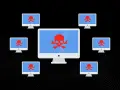Komputery z czerwonymi czaszkami na ekranach, symbolizujące atak DDoS.