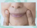 Fingers press into the cheeks, creating dimples. Could this be one of the unexpected side effects of face yoga?