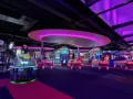 Bunte Spielautomaten und Air-Hockey-Tische in einem beleuchteten Gamestate Potsdamer Platz.