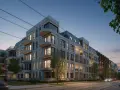 Nowe inwestycje Poznań: nowoczesne apartamentowce z balkonami i mansardowymi dachami, oświetlone wieczornym światłem, przy ulicy z torami tramwajowymi.