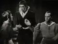 Trzej mężczyźni w strojach historycznych. Leszek Herdegen w środku, z wyrazem skupienia na twarzy, trzyma dłoń innego aktora.
