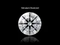 A brilliant round cut simulant diamond sparkles against a black background, showcasing its facets and fire.