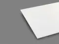 A white sheet of plexiglass is shown on a gray background. This material is known for being heat resistant, making it suitable for various applications.