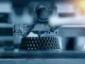 Close-up of an advanced 3D printing machine creating a complex, lattice-like object layer by layer.