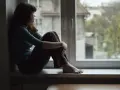 Dziewczyna siedzi na parapecie, patrząc przez okno. Czy to melancholia co to? Smutek i zaduma w jej oczach.