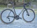 A dark blue Orbea Orca road bike with gold lettering, Ultegra components, and deep-dish wheels. This is a great bike for an Orbea Orca review.
