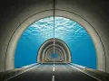 An underwater tunnel with a road leading into the distance. This surreal scene makes you wonder, does the Eurostar go underwater?