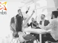 Zespół świętuje sukces, rzucając papierami. Różne osobowości MBTI pracują razem, tworząc dynamiczną atmosferę.