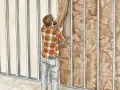 Hombre colocando aislamiento en una estructura metálica para insonorizar habitación.