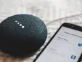 A smart speaker and phone display "Welcome Home" and "1 device found," showcasing modern iot design for a connected home.