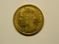Une pièce de 1 franc 1948, en or, avec le profil d'une femme couronnée de blé. "République Française" est gravé sur le pourtour.