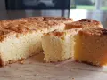 Un delicioso pastel bretón, dorado y esponjoso, cortado en porciones sobre una tabla de madera.