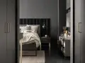 Szare ściany idealnie komponują się z czarnymi meblami, tworząc elegancką i nowoczesną sypialnię.