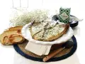 Deliciosa ventresca al horno, servida con pan tostado y hierbas frescas. Un plato perfecto para disfrutar.