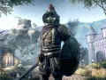 Guerrero con armadura dorada y escudo redondo, listo para la batalla en The Elder Scrolls: Blades.