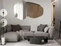 Nowoczesny salon z szarą sofą, geometrycznym lustrem i designerską lampą.