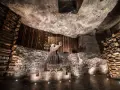 Kopalnia soli Wieliczka ciekawostki: rzeźba górnika Mikołaja Kopernika w solnej komorze, otoczona drewnianymi belkami i solnymi ścianami.