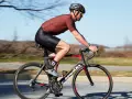 Cyclist in motion, demonstrating optimal road bike seat height for efficient pedaling.