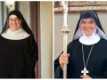 Two smiling nuns in traditional black habits and white wimples. This is what Catholic monks wear, along with a cross necklace and a staff.