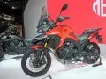 Pomarańczowy motocykl Morbidelli T1002VX na wystawie, gotowy na przygodę. Obok stoi jego szary brat.