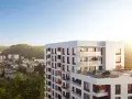 Nowe inwestycje Gdynia: nowoczesny apartamentowiec z tarasami i widokiem na zieleń.
