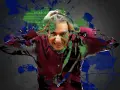 Un homme se tient la tête, l'air angoissé. Des éclaboussures vertes et bleues recouvrent l'image, évoquant le chaos mental. Le texte "anxious" et "panic disorder" apparaît, suggérant qu'il souffre peut-être d'acouphènes.