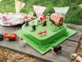 Torta per bambini a tema fattoria con mucca, casetta, trattore e animali.