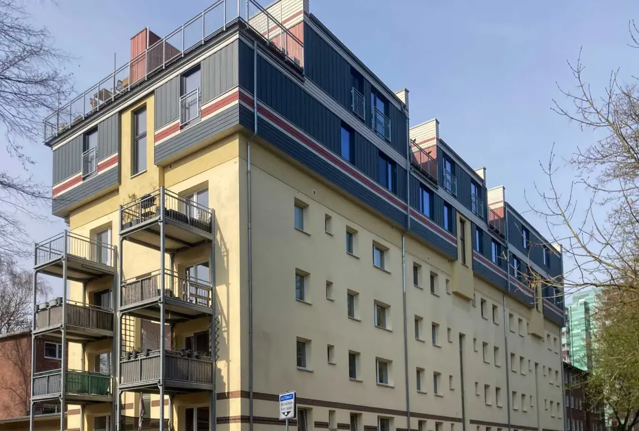 Modernes Mehrfamilienhaus mit Balkonen und auffälliger Fassadengestaltung im **Vorort**.
