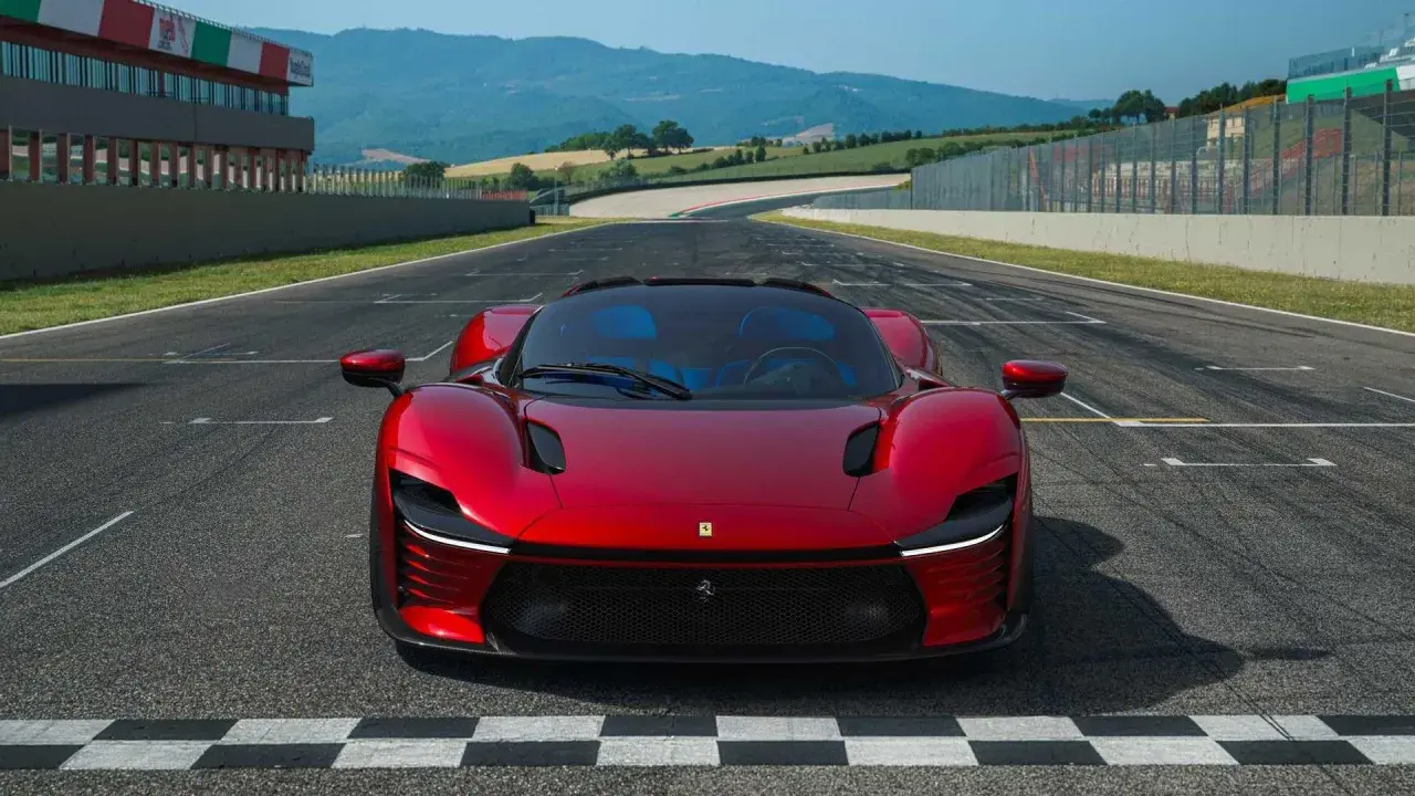 Czerwone Ferrari Daytona SP3 na linii startu toru wyścigowego, gotowe do przekroczenia mety.