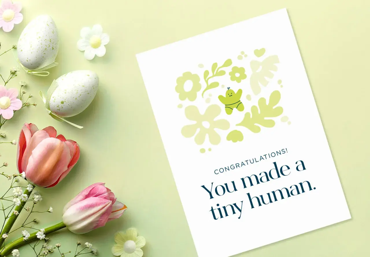 Gratulacje z okazji narodzin dziecka! Urocza kartka z motywem kwiatowym i małym ludzikiem.