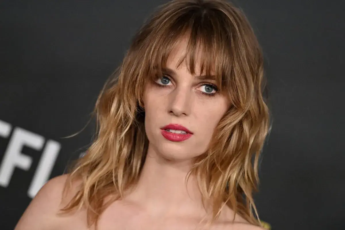 Maya Hawke, znana z filmów, seriali i programów, z burzą blond włosów i wyrazistymi ustami.