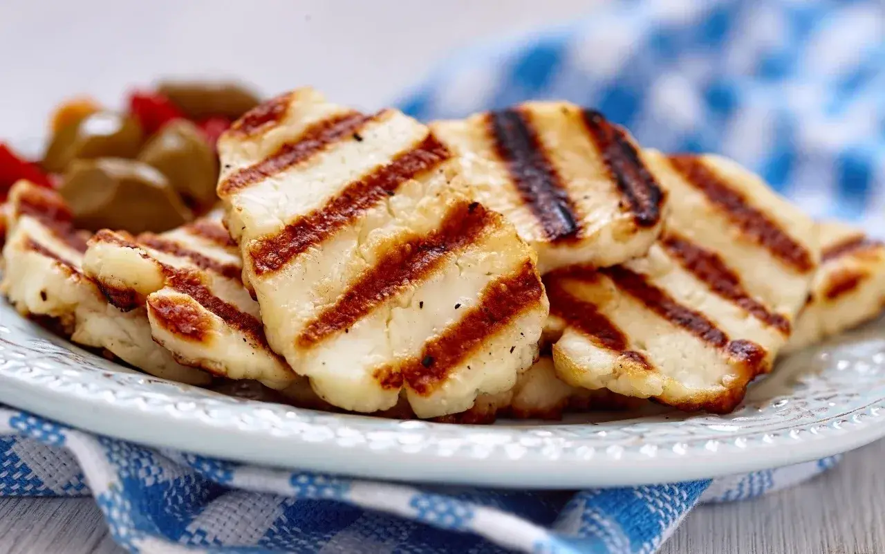 Grillowany ser halloumi na talerzu, z widocznymi paskami z grilla. Idealny dodatek do sałatek, z niską zawartością halloumi kcal.