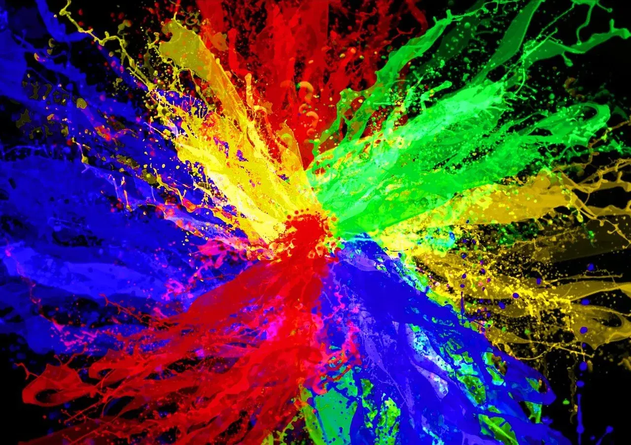 Eksplozja kolorów: czerwony, zielony i niebieski tworzą dynamiczną paletę kolorów RGB na czarnym tle.