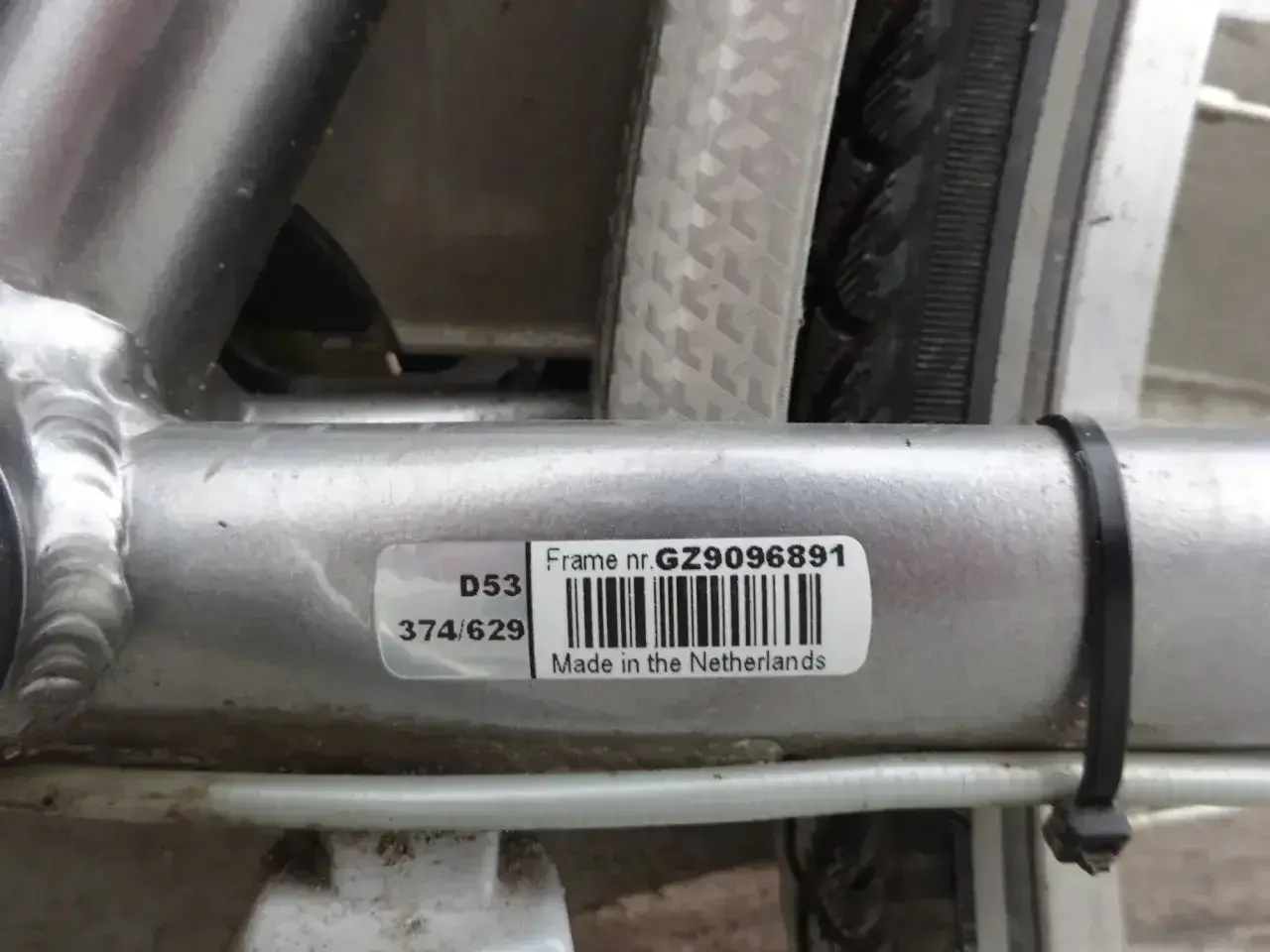 Naklejka z numerem ramy roweru: GZ9096891. Wyprodukowano w Holandii.