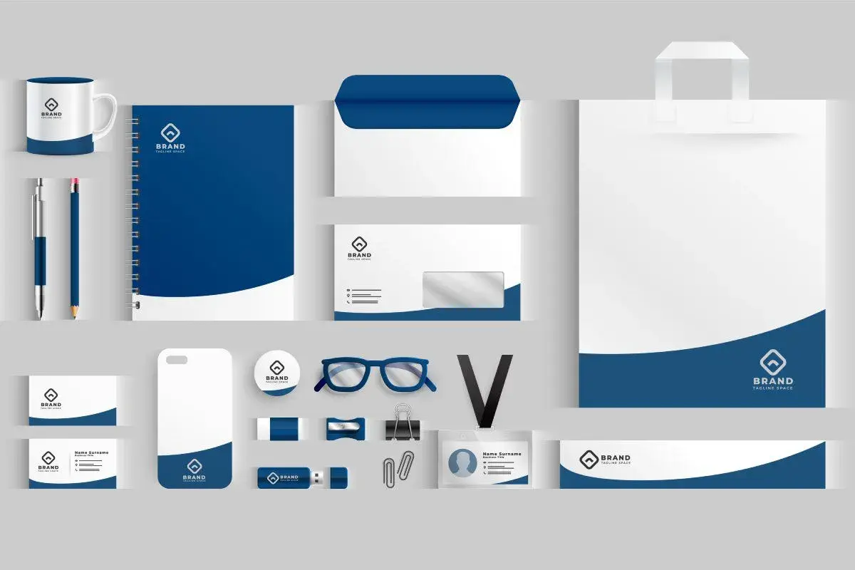 Zestaw materiałów biurowych: kubek, notes, koperty, torba, wizytówki, etui na telefon, identyfikator, pendrive. To jest mockup co to jest.
