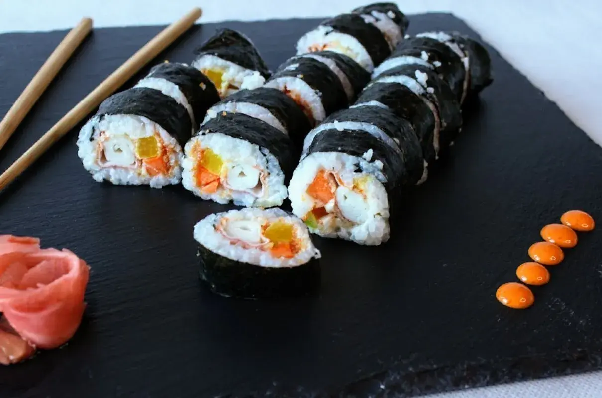 Roladki sushi z paluszkami surimi, marchewką i papryką. Prosty sposób, jak przygotować paluszki surimi do sushi.