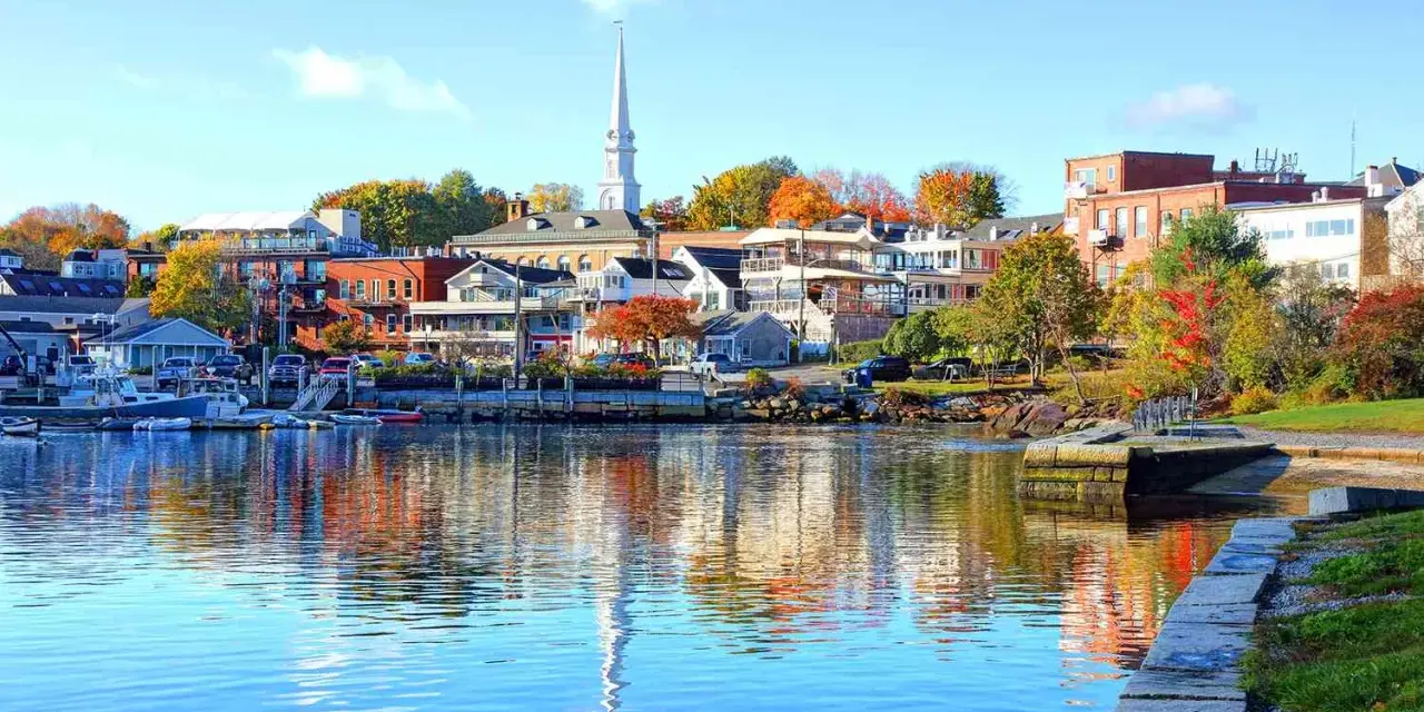A charming New England harbor town with colorful autumn foliage, perfect for weekend getaways.