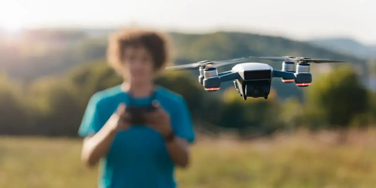A person controls a drone, unaware of the potential penalty for flying a drone without a license.