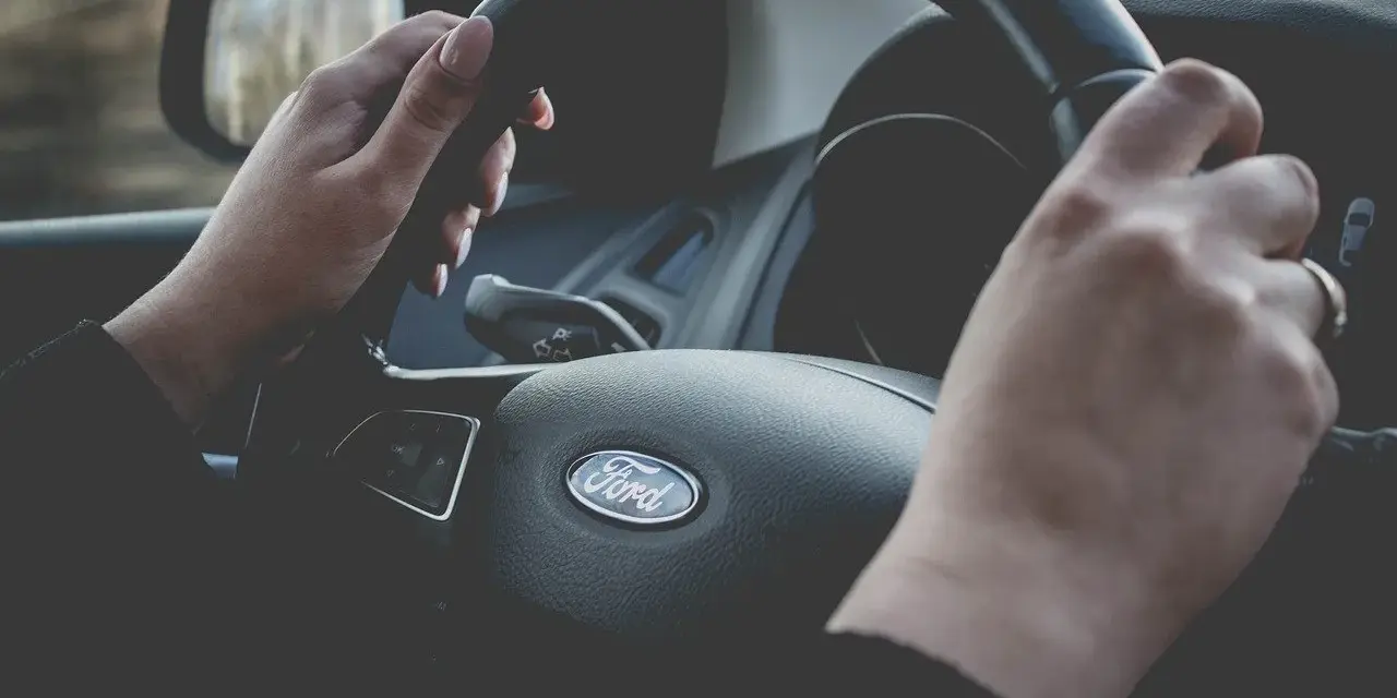 Dłonie trzymające kierownicę samochodu Ford.