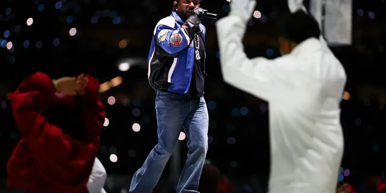 Un rappeur sur scène, micro en main, devant une foule lumineuse. Une performance qui rappelle l'énergie du rap francais.