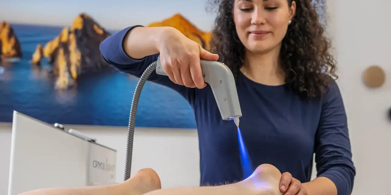 Therapeutin behandelt Fersensporn mit Kälteanwendung. Die Cryo-Therapie lindert Schmerzen, wie bei Liebscher & Bracht empfohlen.