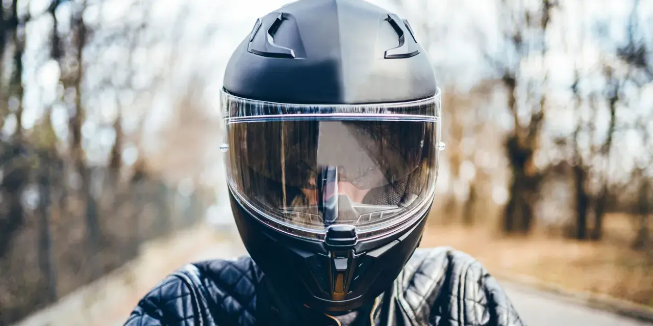 Casco moto nero con visiera trasparente, pronto per la strada. La scadenza del casco moto è un promemoria per la sicurezza.