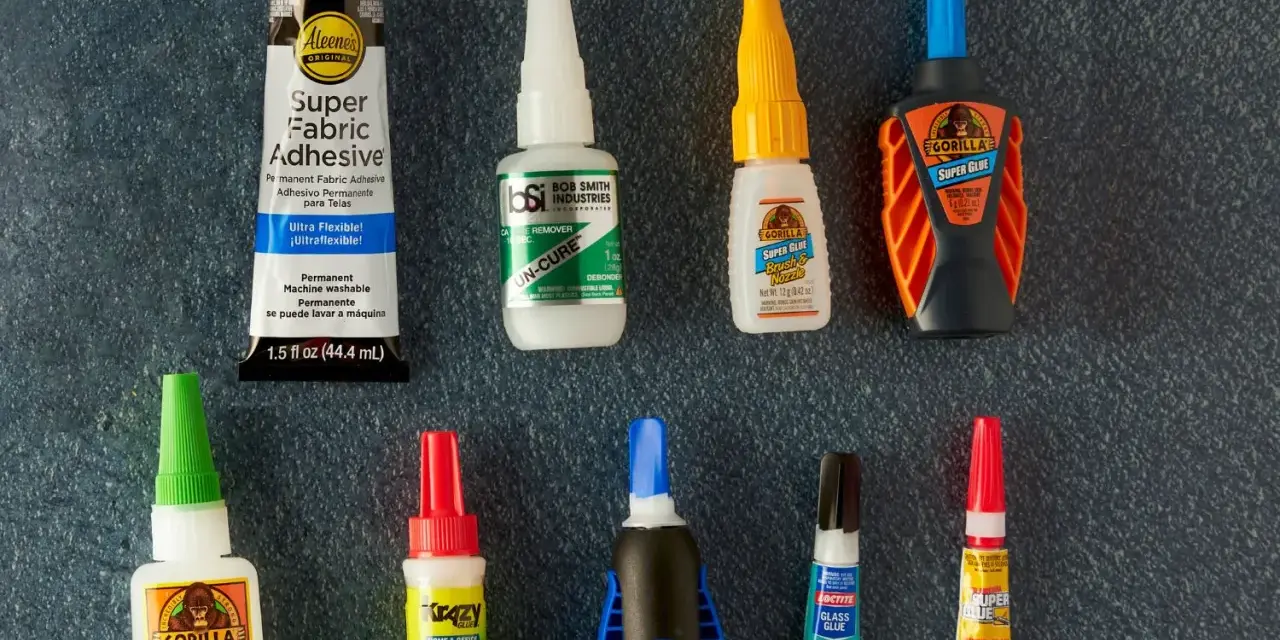 A collection of super glue bottles, including Gorilla Glue and Krazy Glue, are laid out for a comparison of bondic vs super glue.